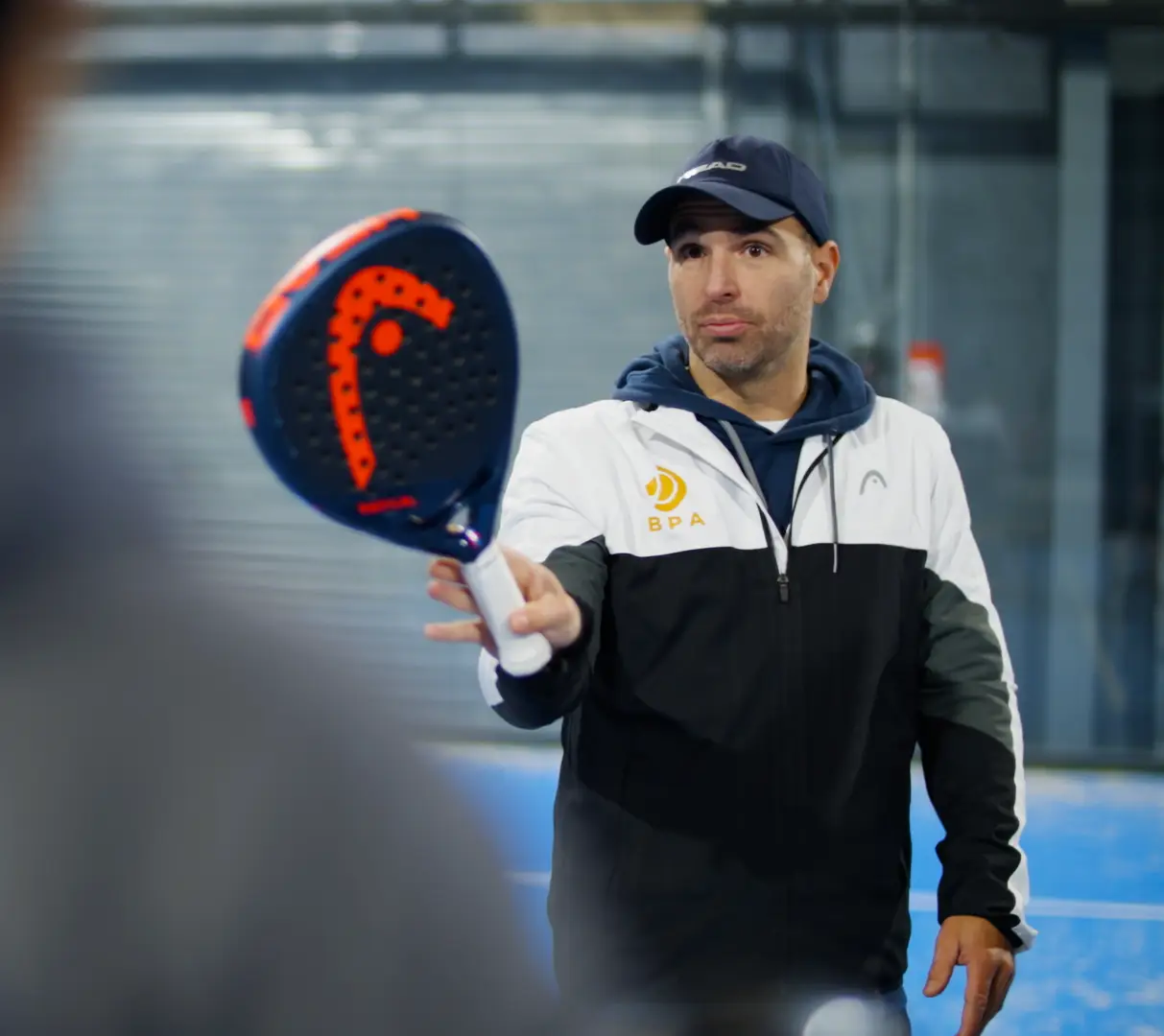 Dan, founder of British Padel Academy, coaching on court