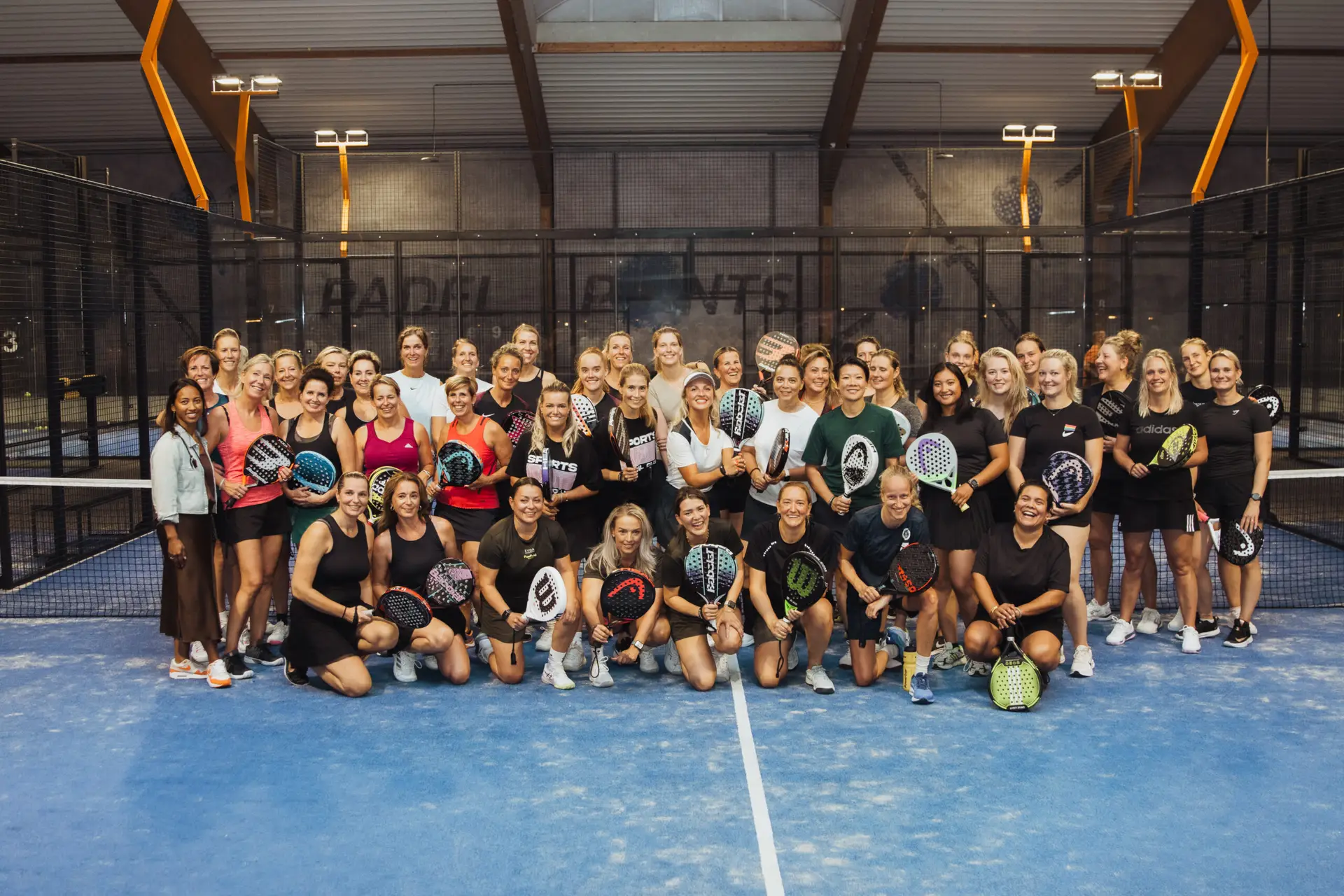 FemPadel Collective group pic on padel court