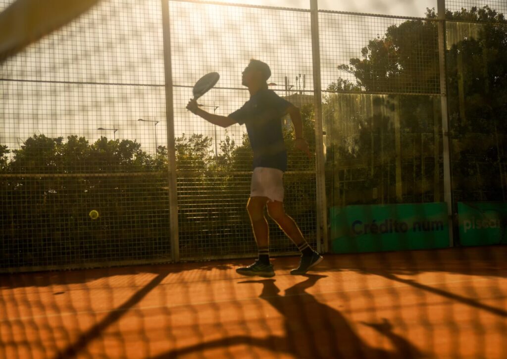 Person playing padel on court