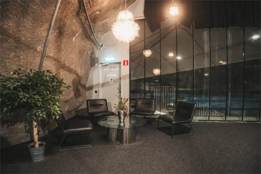 Lounge area at Cave Padel, seats and a table