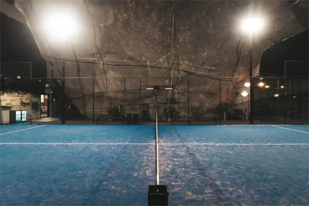 Padel court with lights inside Cave Padel, Stockholm. Looking down the net