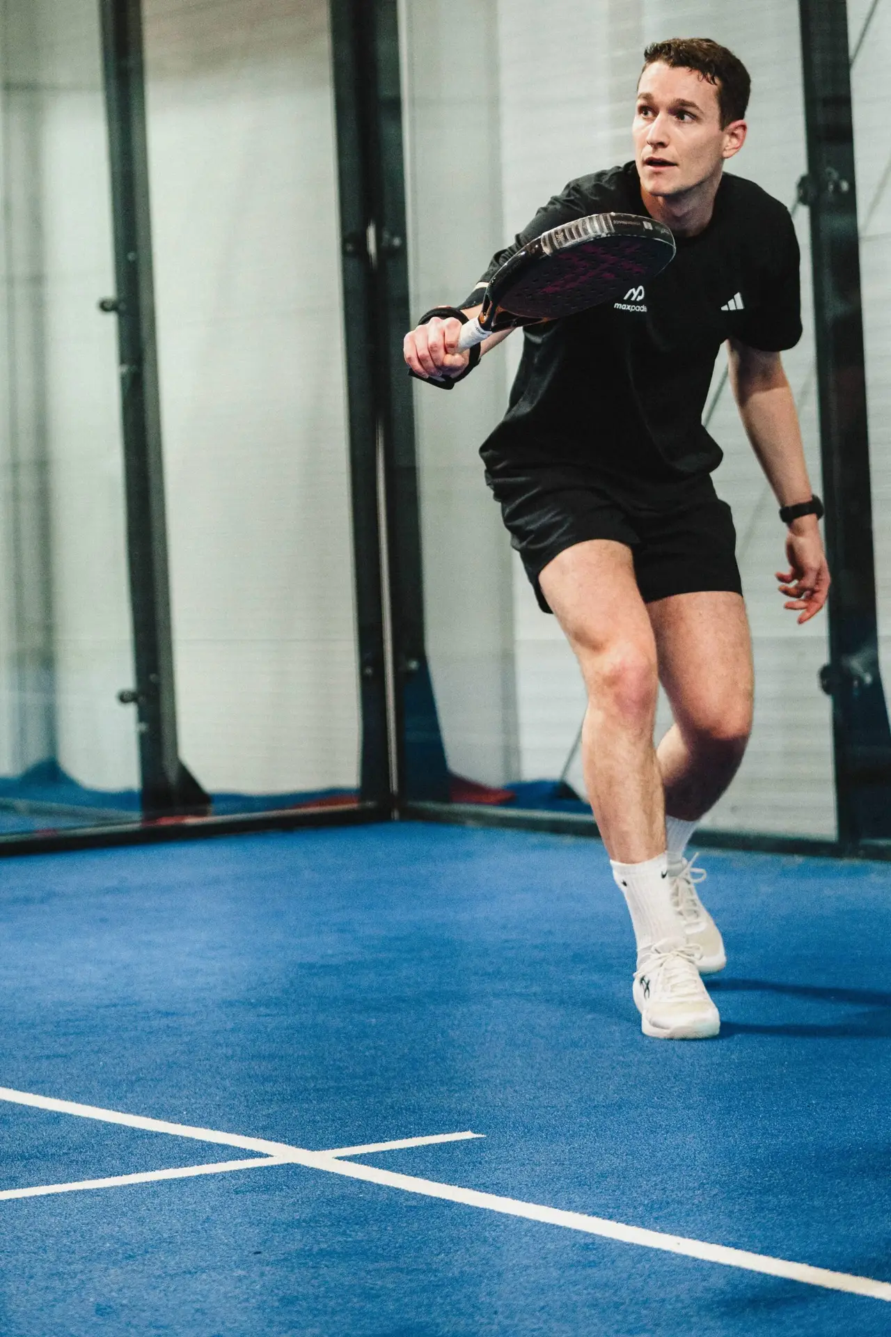 Max England playing padel on court
