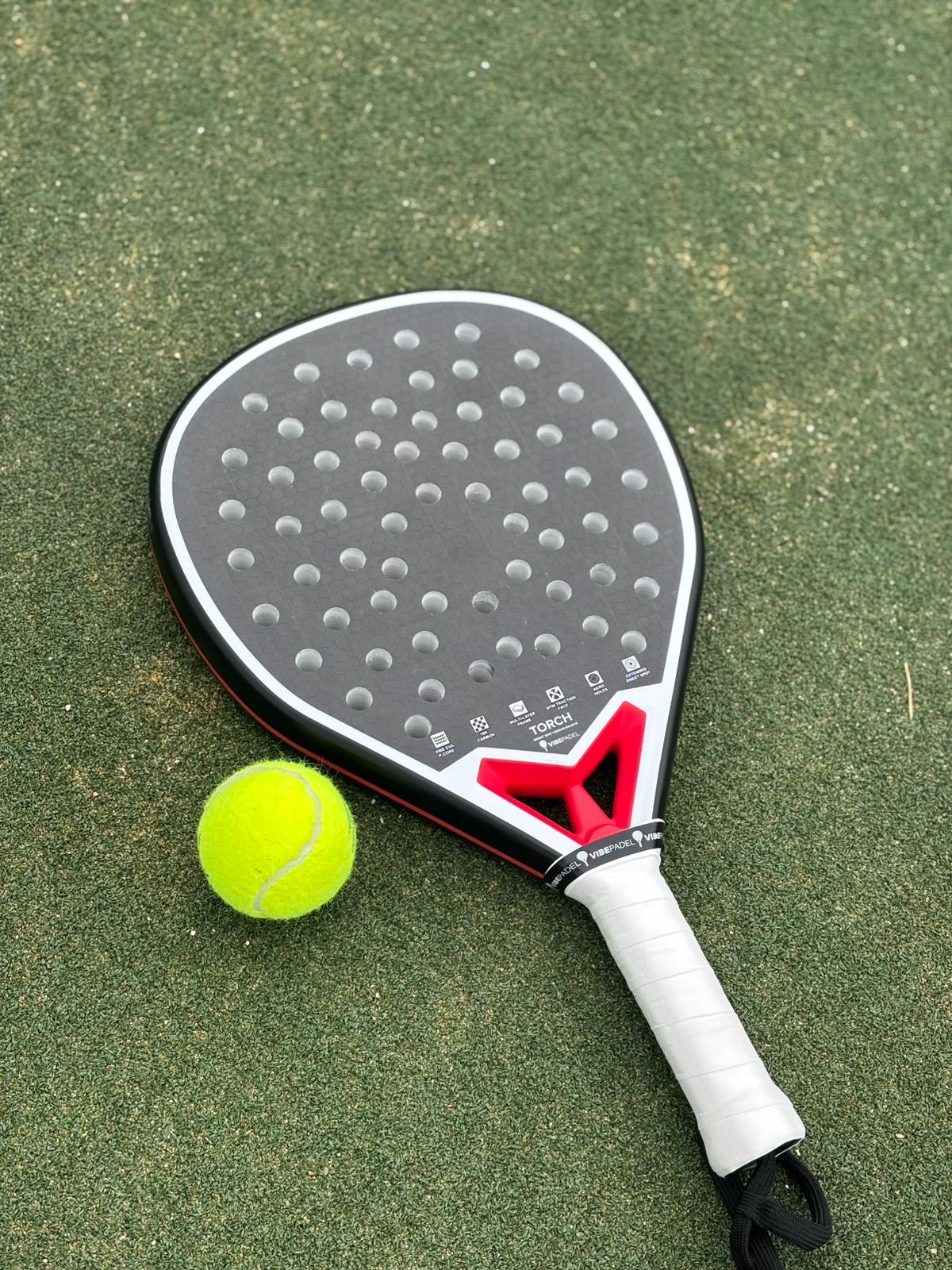 VIBEPadel racket and padel ball on court