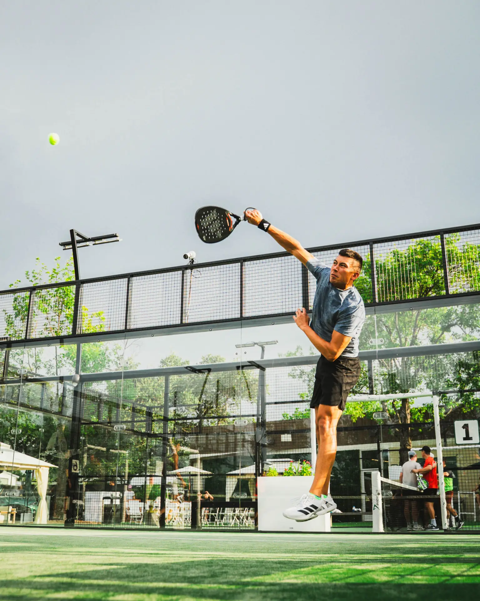 Bryant Salcedo smashing padel ball on court