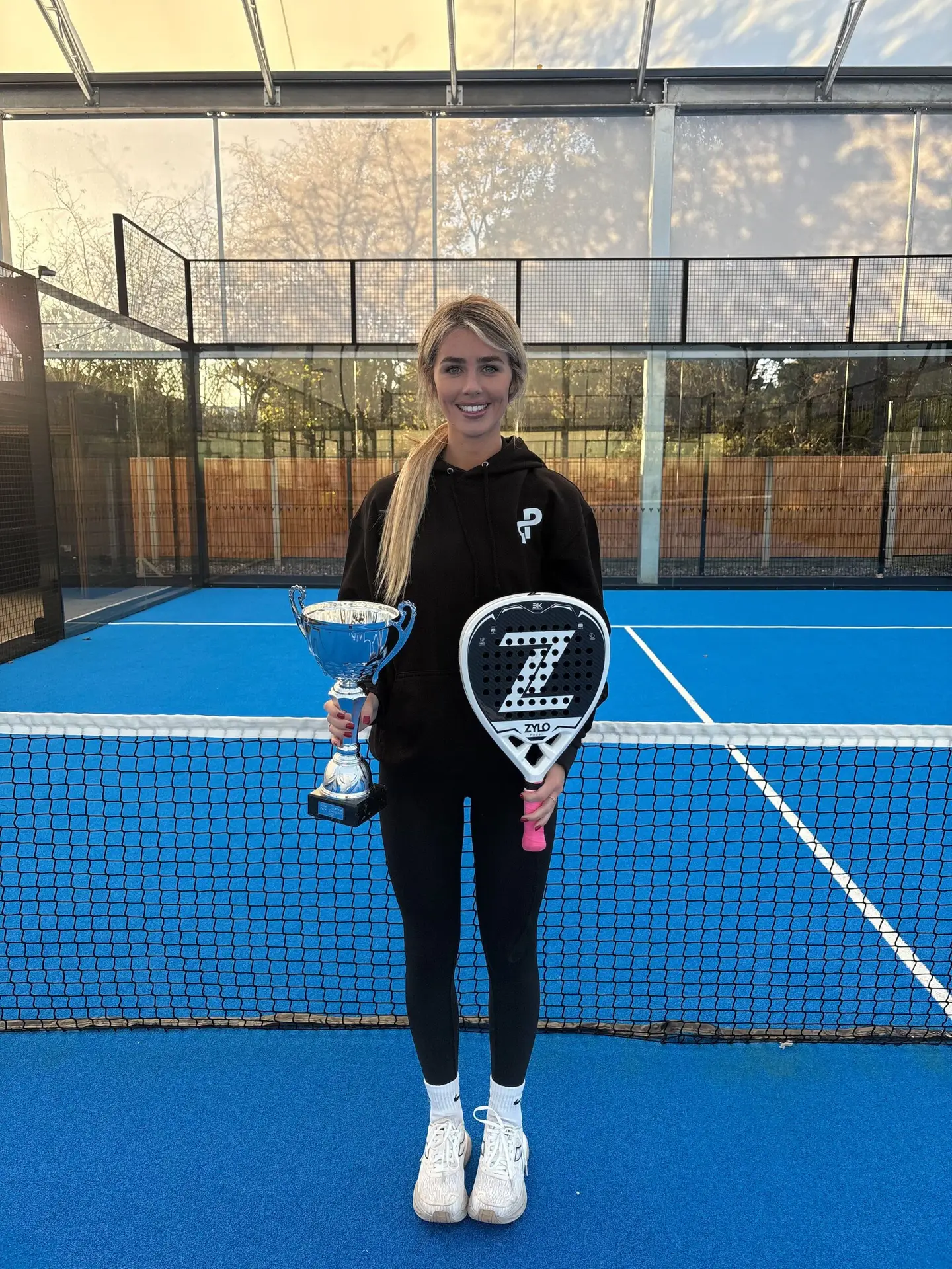 Ellie Tsimbilakis on padel court with a trophy