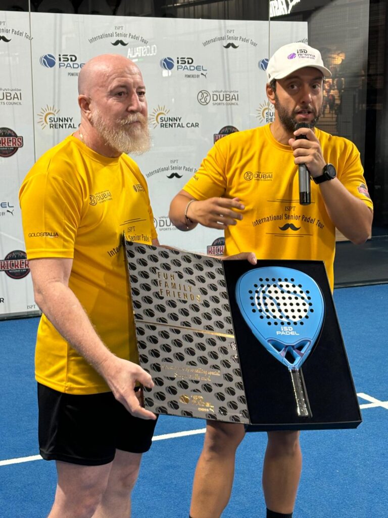 Roque Roasio holding padel racket prize on court
