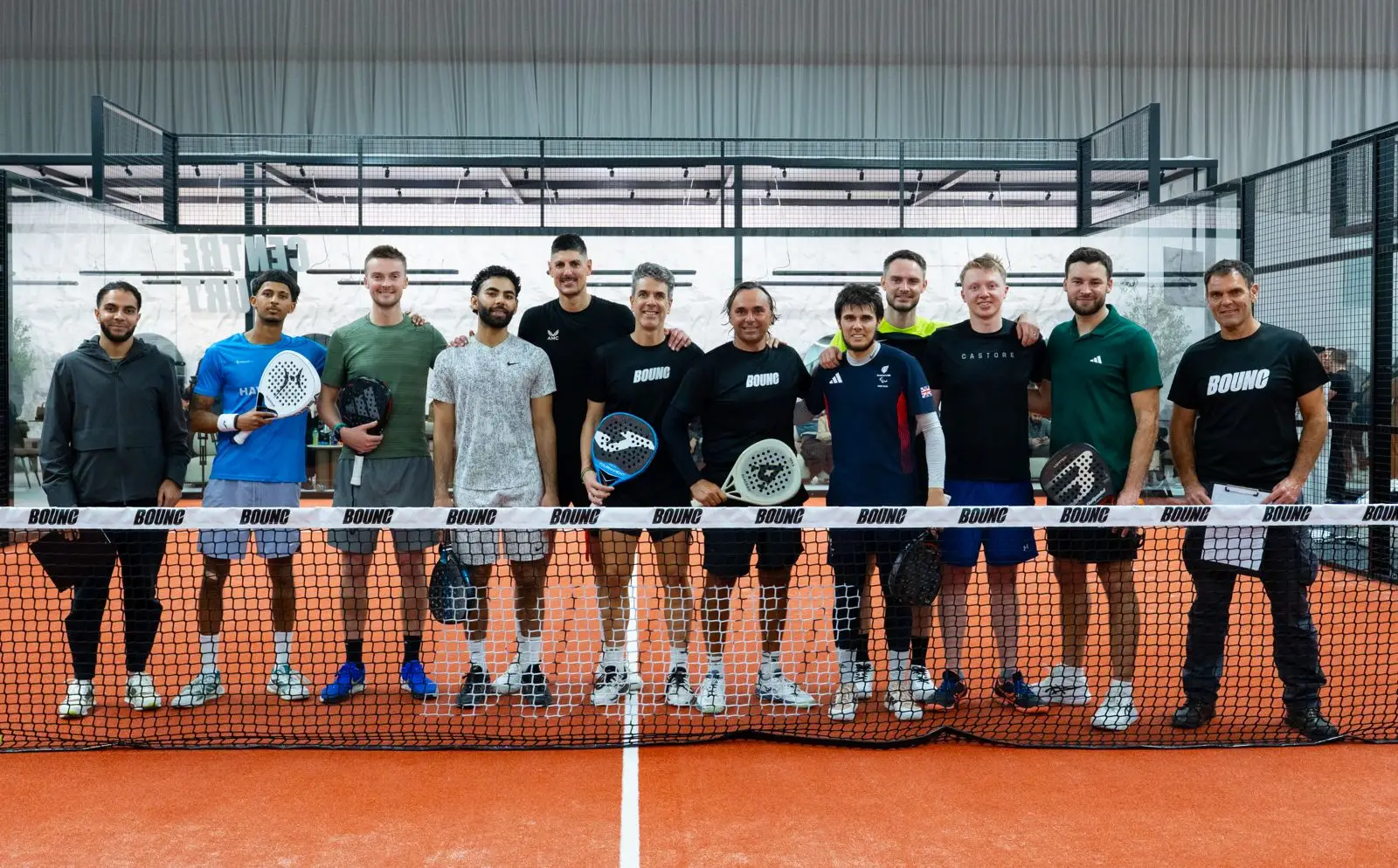 BOUNC people on court behind padel net