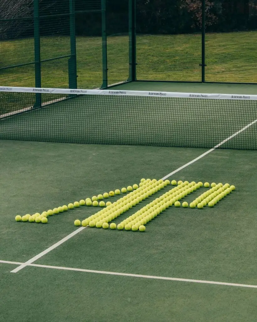 Balls on padel court arranged to spell AP