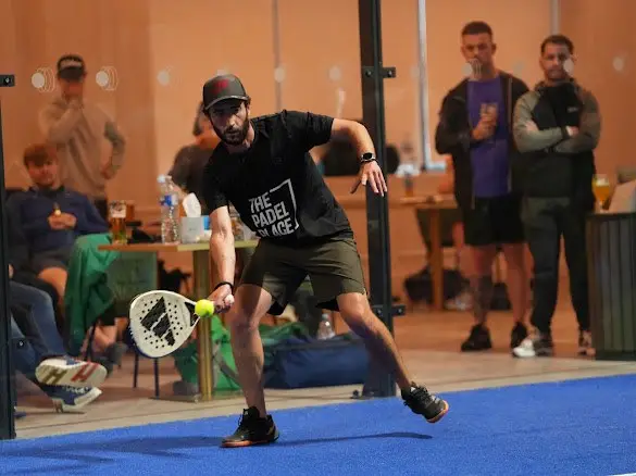 Jamie Guest playing a low forehand on court